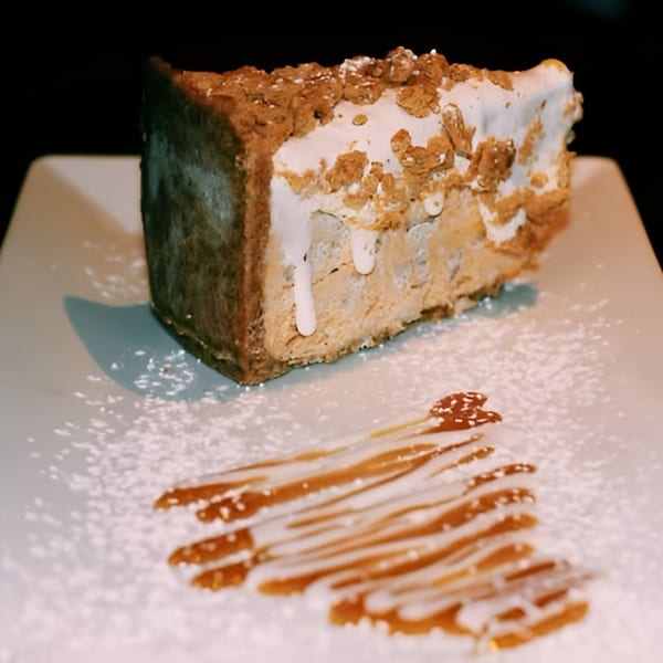 A slice of Esposito's Pizza Bar Restaurant's Italian dessert, topped with crunchy bits and drizzled with caramel.