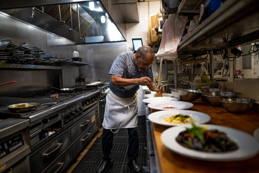 chef preparing meals at Espositos Pizza Bar and Restaurant Kitchen